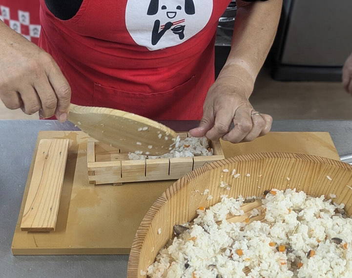 押し抜きに酢飯を詰めていく工程